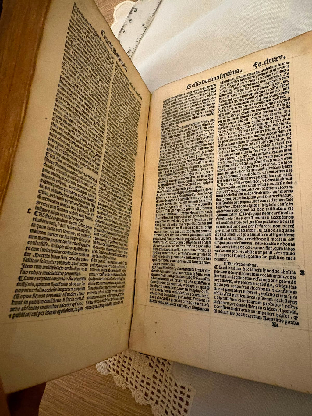A text opening from the decrees of the Council of Basel, headed Concilii Basiliensis, printed in two columns of Gothic black letter with printed foliation and marginal section letters.
